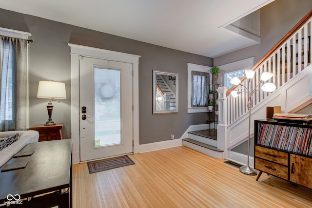 entryway with hardwood / wood-style floors