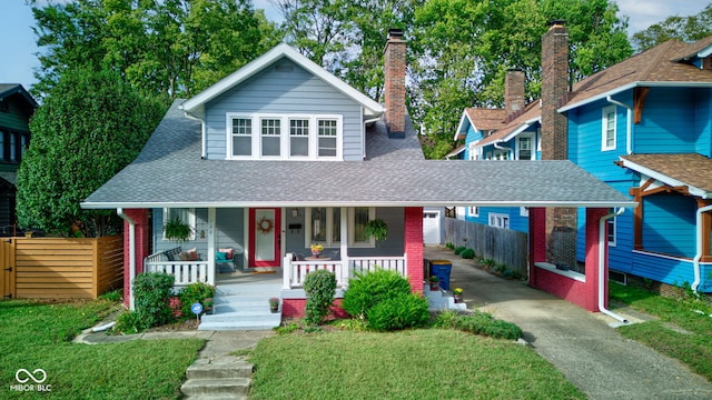 view of front of house featuring covered porch and a front lawn