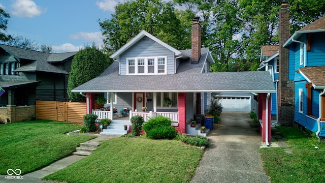 view of front of house with a garage, a front lawn, and a porch