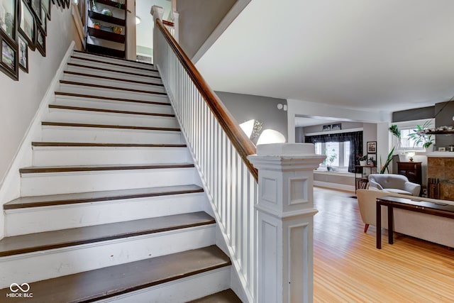 staircase with hardwood / wood-style floors