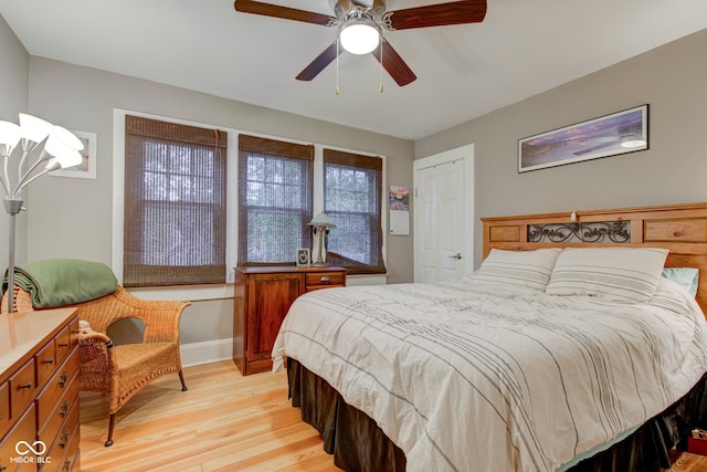 bedroom with ceiling fan and light wood-type flooring