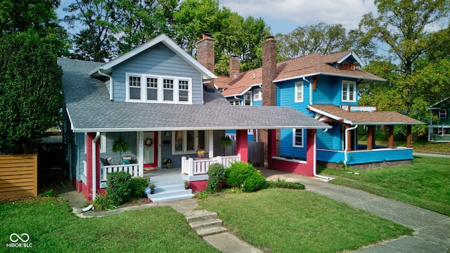 view of front of house with covered porch and a front yard