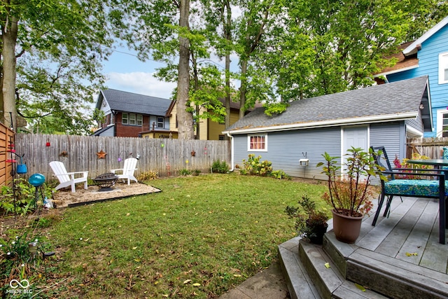 view of yard featuring a deck and an outdoor fire pit