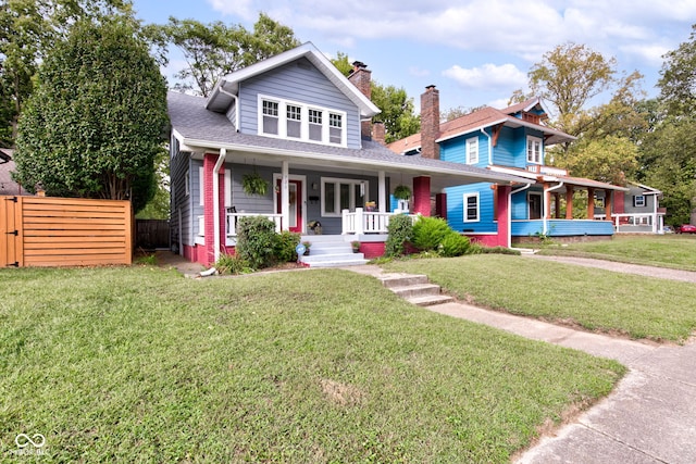 view of front facade featuring a front lawn and covered porch