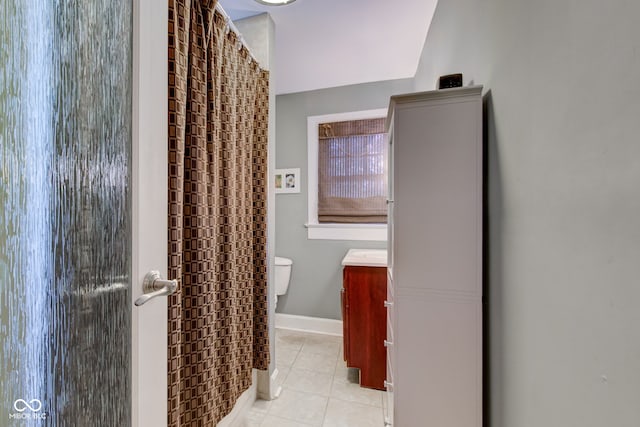 bathroom with tile patterned flooring, vanity, and toilet