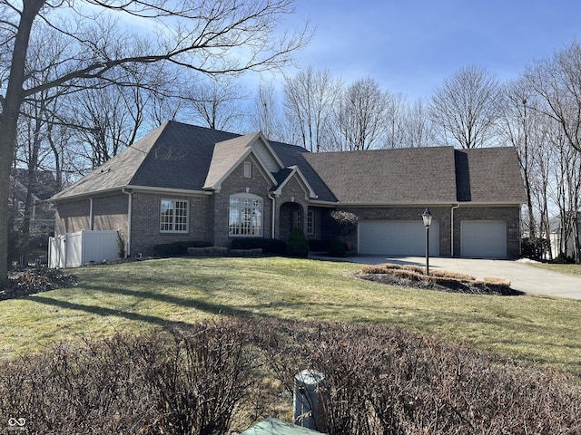 ranch-style home with a garage and a front yard