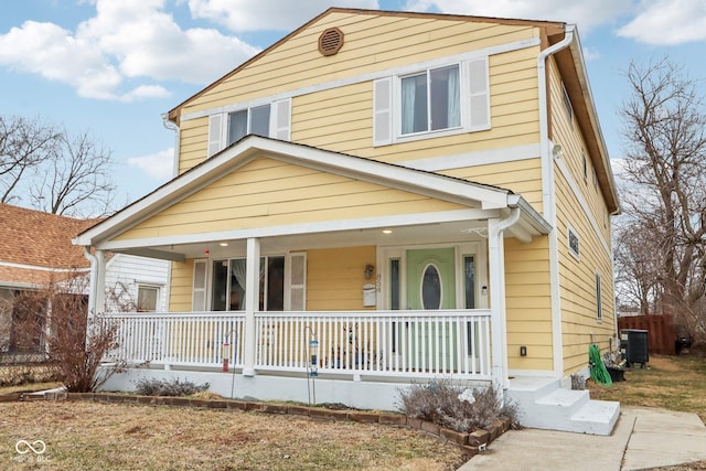 view of front of property featuring cooling unit and a porch