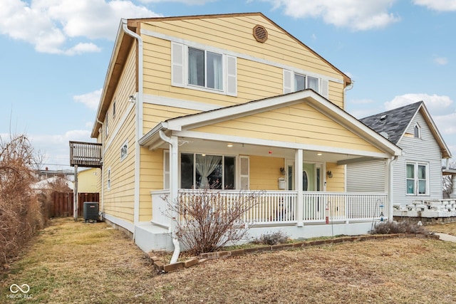 view of front facade with a porch, central AC, and a front yard