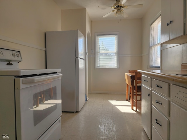 kitchen with baseboards, white appliances, white cabinetry, and ceiling fan