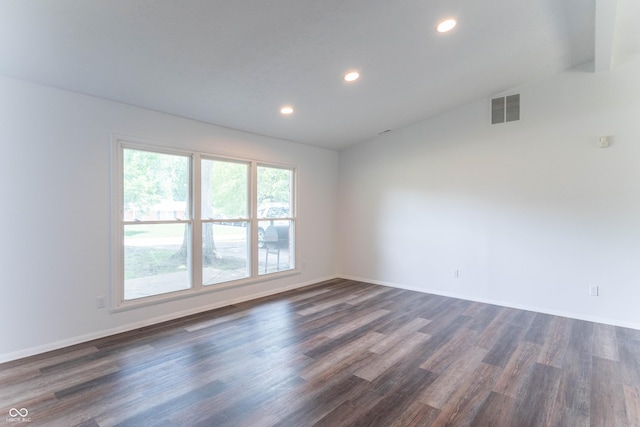 empty room with recessed lighting, visible vents, baseboards, and dark wood-style flooring