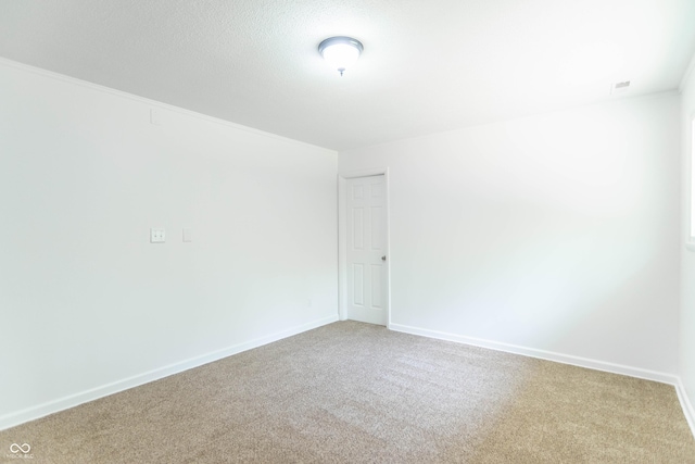 carpeted spare room with baseboards