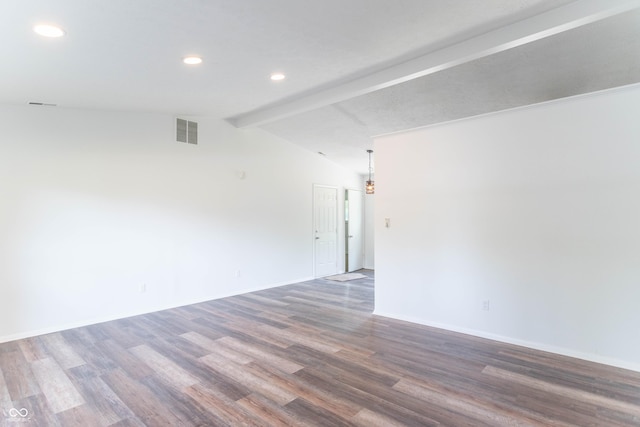 spare room with visible vents, vaulted ceiling with beams, baseboards, recessed lighting, and wood finished floors