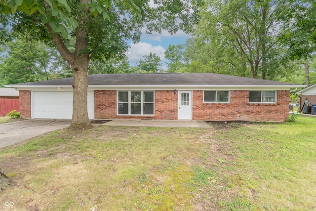 single story home featuring a garage, driveway, brick siding, and a front lawn