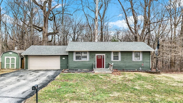 single story home with a garage and a front lawn