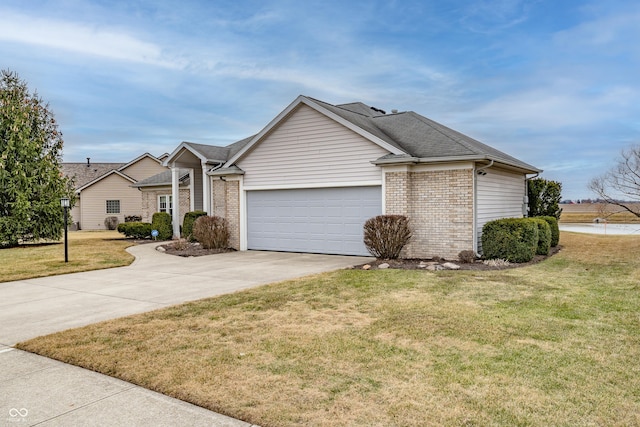 single story home with a garage, driveway, a front lawn, and brick siding