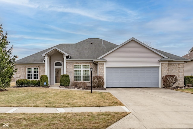 view of front facade with driveway, a front lawn, an attached garage, and brick siding