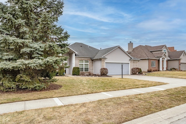 view of front of house with concrete driveway, brick siding, a front lawn, and an attached garage