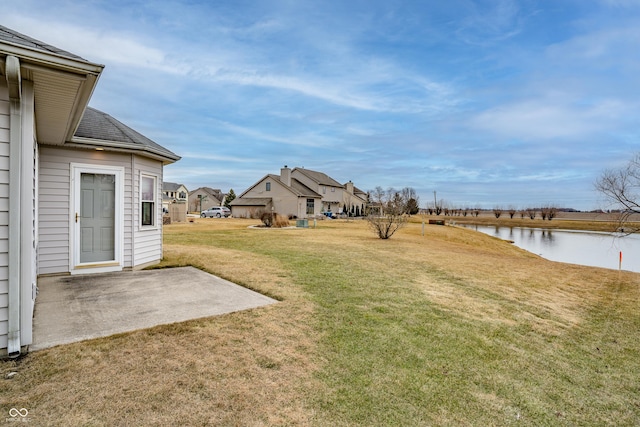 view of yard with a patio area and a water view