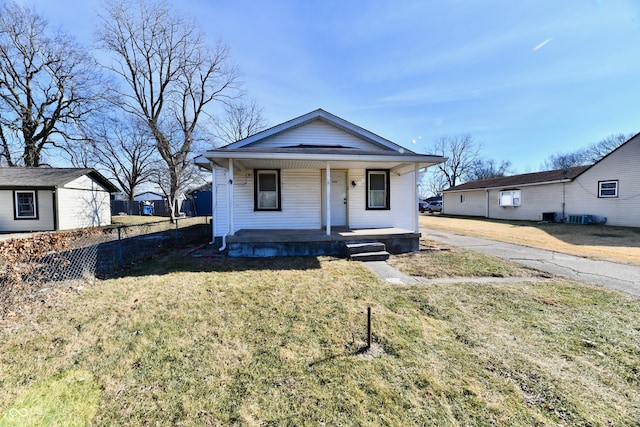 bungalow-style home with a front yard and covered porch