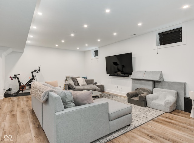 living area with light wood finished floors and recessed lighting