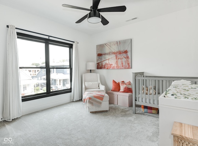 bedroom featuring light carpet, ceiling fan, and visible vents