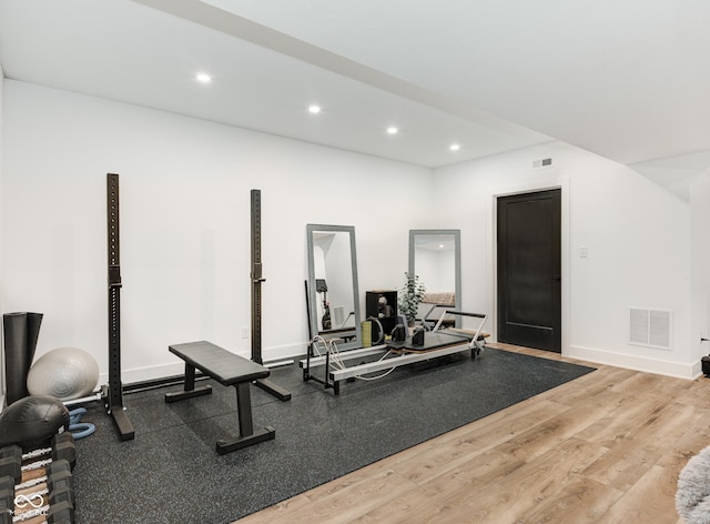 exercise room featuring recessed lighting, wood finished floors, visible vents, and baseboards