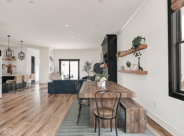 dining room featuring light wood-style floors, baseboards, and recessed lighting