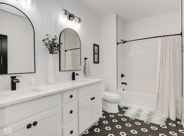 full bathroom featuring shower / tub combo, a sink, toilet, and double vanity