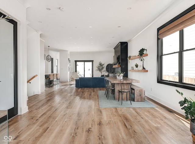 dining area featuring baseboards and light wood finished floors