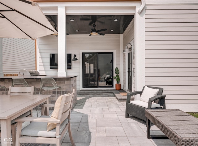 view of patio / terrace featuring outdoor wet bar, an outdoor kitchen, and a ceiling fan