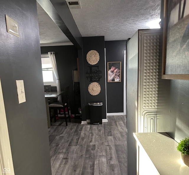 interior space with dark wood-type flooring and a textured ceiling