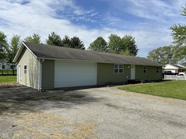 ranch-style house featuring fence and a front yard
