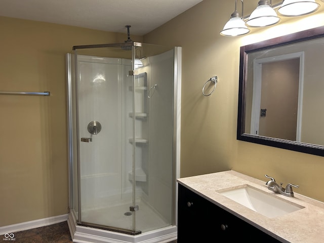 bathroom with vanity, baseboards, a ceiling fan, and a shower stall