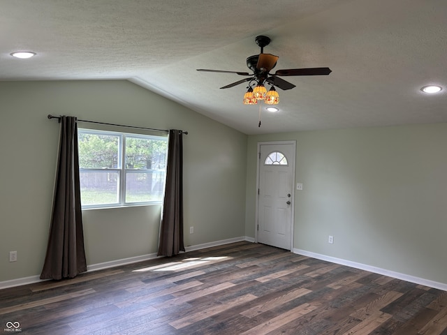 entryway featuring baseboards, a ceiling fan, dark wood-style flooring, and vaulted ceiling