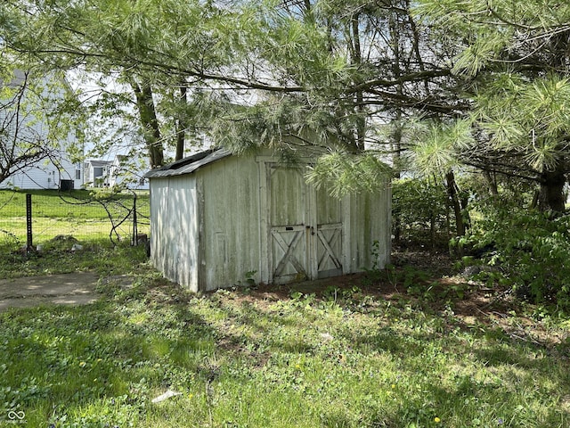 view of shed with fence