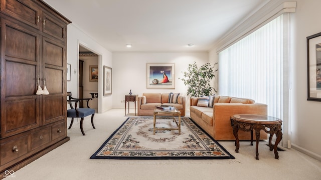 living room featuring crown molding, light colored carpet, and baseboards