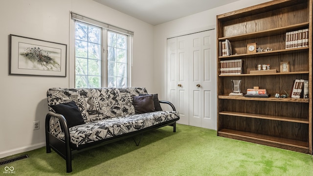 living area featuring carpet, visible vents, and baseboards