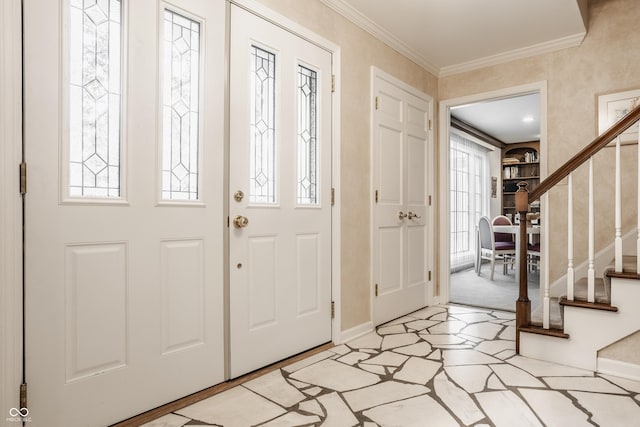 foyer featuring stairway, baseboards, and ornamental molding