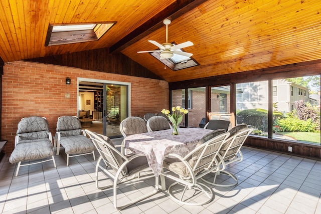 sunroom featuring lofted ceiling with skylight, wood ceiling, and ceiling fan