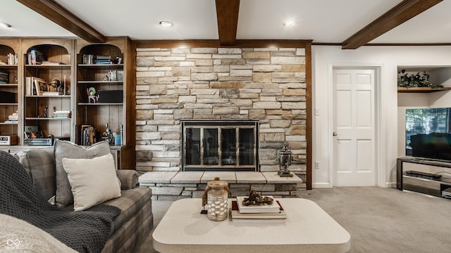 carpeted living area featuring beamed ceiling, a stone fireplace, crown molding, and baseboards