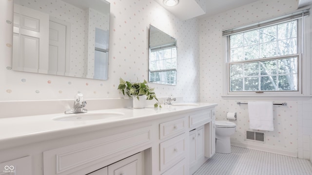 full bathroom with a sink and wallpapered walls