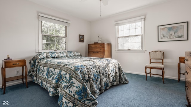 carpeted bedroom featuring multiple windows, a ceiling fan, and baseboards