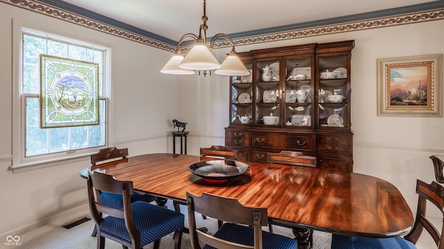 carpeted dining area featuring plenty of natural light and visible vents