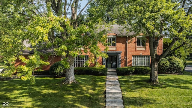 view of front facade featuring a front lawn and brick siding