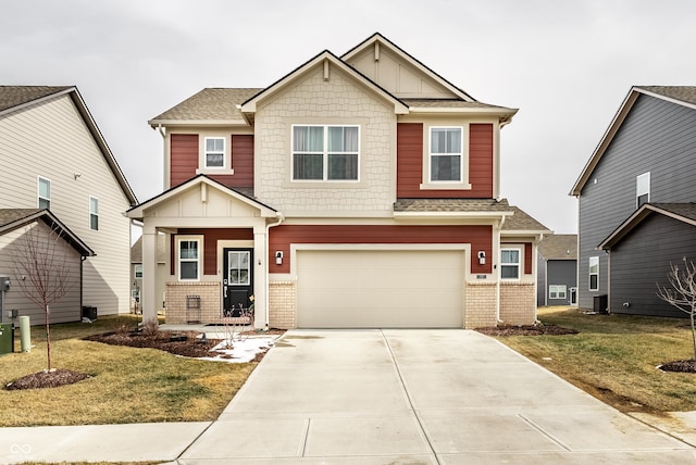 craftsman inspired home featuring an attached garage, driveway, brick siding, and a front yard