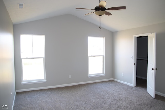 spare room with lofted ceiling, carpet floors, and ceiling fan