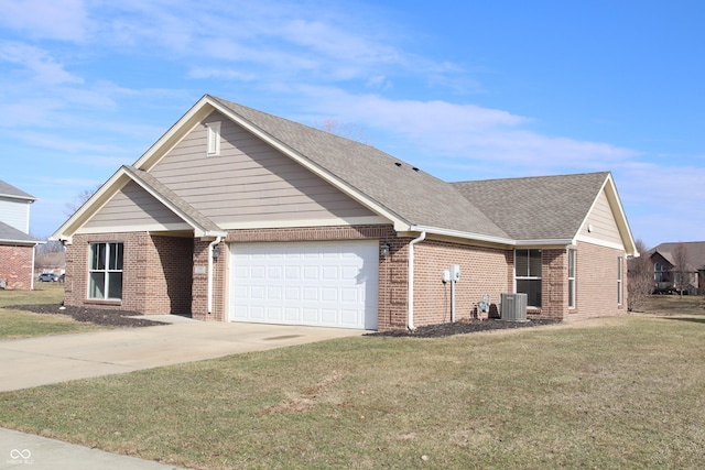 view of front facade with central AC unit, a garage, and a front yard