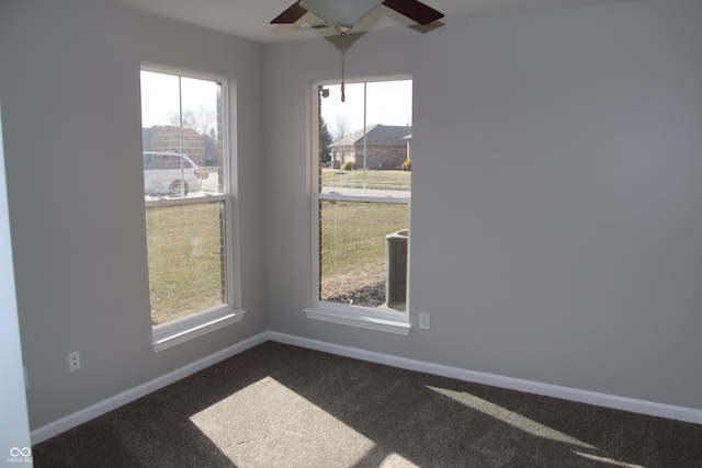 carpeted empty room featuring ceiling fan