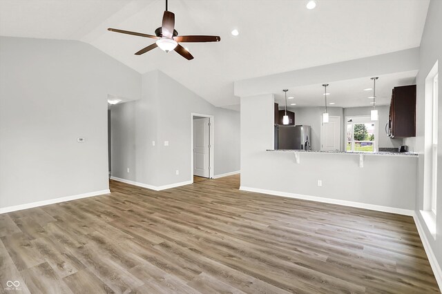 1393 N Salem Ct, Greenfield, IN 46140 - unfurnished living room featuring ceiling fan, vaulted ceiling, wood finished floors, baseboards, and recessed lighting