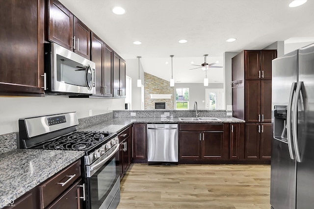 1393 N Salem Ct, Greenfield, IN 46140 - kitchen with appliances with stainless steel finishes, a sink, a ceiling fan, light wood-type flooring, and stone countertops